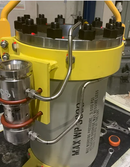 Stainless steel hydraulic tubing bent and clamped to a pressure vessel assembly