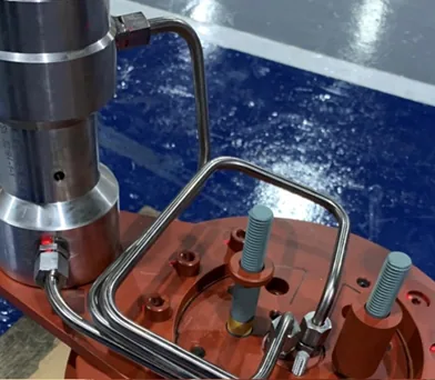 Precision-bent tubing routed around a hydraulic actuator and test port