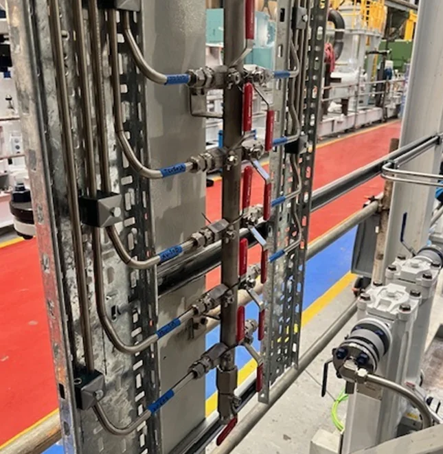 Instrumentation tubing and valve manifolds installed on a compressor package frame